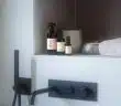 a counter with bottles and a lamp