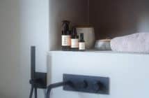 a counter with bottles and a lamp